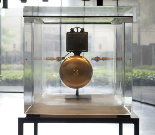 A bell in a glass case