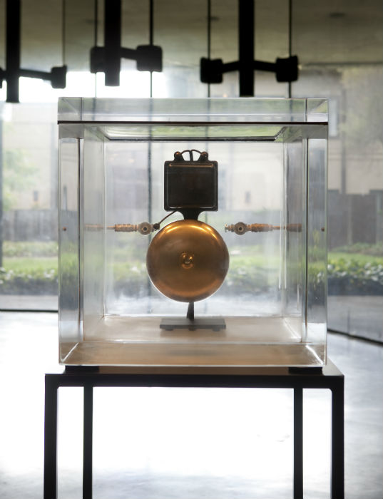 A bell in a glass case
