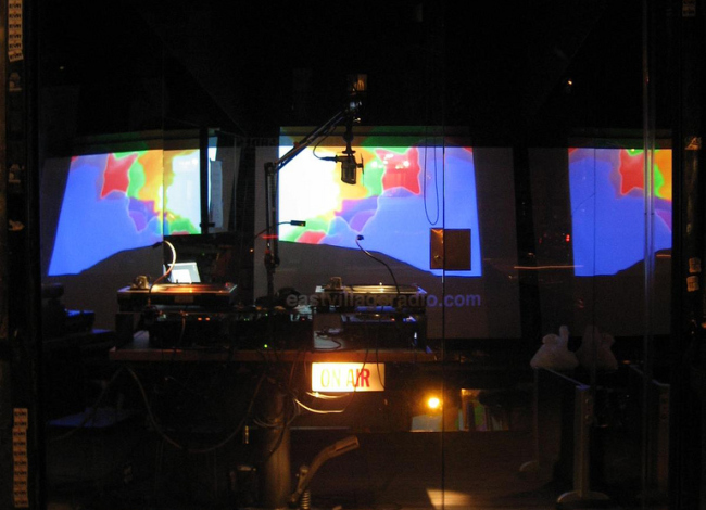 A radio tech booth in a glass enclosure