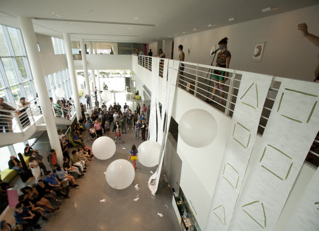 People on the ground floor watching people perform on the second floor (650x470)