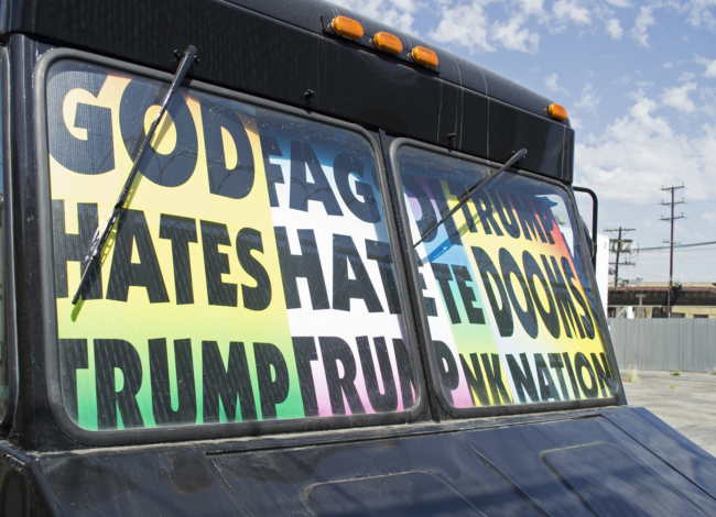 A tank with placards inside that you can see from the windshield; “God hates Trump” (650x470)