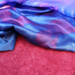A pink rug and a blue fabric